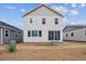 New construction backyard with white siding and a sliding glass door at 45922 Gentry Ave, Bennett, CO 80102