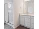 Modern bathroom with a glass-enclosed shower and a vanity with a large mirror at 45922 Gentry Ave, Bennett, CO 80102