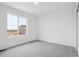 Bright bedroom featuring neutral carpets, and a large window letting in plenty of natural light at 45922 Gentry Ave, Bennett, CO 80102