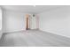 Spacious bedroom with neutral carpet, white walls, and abundant natural light at 45922 Gentry Ave, Bennett, CO 80102