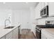 Modern kitchen with sleek countertops, stainless steel appliances, and wood-look flooring at 45922 Gentry Ave, Bennett, CO 80102