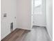 Well-lit laundry room with wood-style flooring and hookups at 45922 Gentry Ave, Bennett, CO 80102
