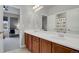 Bright bathroom with a double vanity and a view of a desk area at 1820 Ghost Dance Cir, Castle Rock, CO 80108