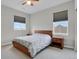 Cozy bedroom with a ceiling fan, two windows, and two nightstands at 1820 Ghost Dance Cir, Castle Rock, CO 80108