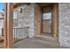Welcoming entryway with stone accents, front door, and small front porch at 1820 Ghost Dance Cir, Castle Rock, CO 80108