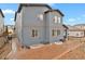 Exterior view showing a blue two-story home with a brick patio and landscaped yard at 1820 Ghost Dance Cir, Castle Rock, CO 80108