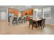Open-concept kitchen and dining area features bar seating, stainless appliances, and wood cabinets at 1820 Ghost Dance Cir, Castle Rock, CO 80108