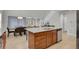 A kitchen island with a sink, stainless steel appliances, and a view of dining area and living room at 1820 Ghost Dance Cir, Castle Rock, CO 80108
