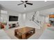 Comfortable living room featuring hardwood floors, staircase, and large TV at 1820 Ghost Dance Cir, Castle Rock, CO 80108