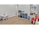 Playroom with light wood floors and gray walls, with storage and a view to the living room at 1820 Ghost Dance Cir, Castle Rock, CO 80108