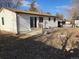 Backyard with a concrete patio, white siding on house, grass, and a wood fence at 16390 E Bates Dr, Aurora, CO 80013