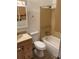 Traditional bathroom with a shower-tub combo, wood cabinets, and ceramic tile at 16390 E Bates Dr, Aurora, CO 80013