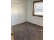 Cozy bedroom featuring neutral carpet, a window with blinds, and a standard closet at 16390 E Bates Dr, Aurora, CO 80013