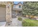 Well-maintained front yard with stone walkway leading to cozy porch at 2420 S Ellis Ct, Lakewood, CO 80228