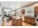 Open kitchen with island flows to a dining area and living room with a cozy fireplace at 2420 S Ellis Ct, Lakewood, CO 80228