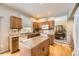 Bright kitchen with granite countertops, island, wood cabinets, and stainless-steel appliances at 2420 S Ellis Ct, Lakewood, CO 80228