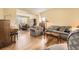 Bright living room with hardwood floors and access to dining area at 2420 S Ellis Ct, Lakewood, CO 80228
