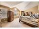 Spacious main bedroom featuring high ceilings, a round window, and plush carpeting at 2420 S Ellis Ct, Lakewood, CO 80228