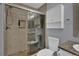 Bathroom featuring a glass shower enclosure, neutral tile, and vanity with white cabinets and granite countertop at 9595 Marmot Ridge Cir, Littleton, CO 80125