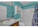 Bright bathroom showcasing a combined bathtub and shower, vanity with sink, blue walls, and medicine cabinet at 9595 Marmot Ridge Cir, Littleton, CO 80125