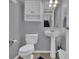Gray bathroom showing a standing sink, toilet, medicine cabinet, and tiled flooring at 9595 Marmot Ridge Cir, Littleton, CO 80125