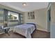 Bright bedroom with blue accent walls, carpet floors, and a closet at 9595 Marmot Ridge Cir, Littleton, CO 80125
