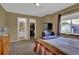 A comfortable bedroom with views into the en suite bathroom and walk-in closet at 9595 Marmot Ridge Cir, Littleton, CO 80125