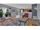Bright living room featuring hardwood floors and an open layout with access to the dining area at 9595 Marmot Ridge Cir, Littleton, CO 80125