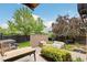 Inviting backyard with a cozy seating area, modern fire pit, and lush landscaping for outdoor enjoyment at 9244 E 37Th Ave, Denver, CO 80238