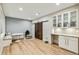Finished basement with wood floors, barn doors, a playroom, and built-in cabinets with counter at 9244 E 37Th Ave, Denver, CO 80238