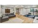 Finished basement with a wood-look floor, home gym, a sectional sofa, and rustic barn doors at 9244 E 37Th Ave, Denver, CO 80238