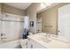 Bright bathroom featuring a shower-tub combo, white vanity, and neutral-toned decor at 9244 E 37Th Ave, Denver, CO 80238