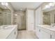 Elegant bathroom featuring a double vanity, glass-enclosed shower, and modern tile at 9244 E 37Th Ave, Denver, CO 80238