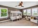Charming bedroom featuring a whimsical bed frame, ceiling fan, and bright windows at 9244 E 37Th Ave, Denver, CO 80238