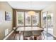 Bright dining area with modern lighting, large windows, and a sliding door to the backyard at 9244 E 37Th Ave, Denver, CO 80238
