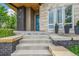 Welcoming front entrance with stone steps and a vibrant blue door at 9244 E 37Th Ave, Denver, CO 80238