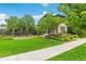Well-manicured front lawn featuring lush greenery, mature trees, and a neatly trimmed lawn at 9244 E 37Th Ave, Denver, CO 80238