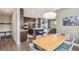 Open-concept kitchen features an island with seating, modern appliances, and flows to the living space at 9244 E 37Th Ave, Denver, CO 80238
