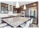 Contemporary kitchen featuring a large island, stainless appliances, and stylish pendant lighting at 9244 E 37Th Ave, Denver, CO 80238