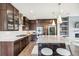 Well-lit kitchen with a spacious island, stainless steel appliances, and sleek cabinetry at 9244 E 37Th Ave, Denver, CO 80238