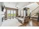 Bright and airy living room with hardwood floors, large windows, and a cozy sofa at 9244 E 37Th Ave, Denver, CO 80238