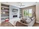 Comfortable living room with built-in shelves, modern fireplace, and large sectional sofa at 9244 E 37Th Ave, Denver, CO 80238