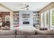 Stylish living room with modern fireplace, built-in shelving, and a comfortable sofa at 9244 E 37Th Ave, Denver, CO 80238
