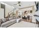 Inviting living space with a staircase, comfortable sofa, and modern kitchen with an island at 9244 E 37Th Ave, Denver, CO 80238