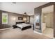 Spacious main bedroom featuring a ceiling fan, window shutters, and en suite bathroom at 9244 E 37Th Ave, Denver, CO 80238
