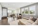 Bright sitting area with large windows, modern shutters, hardwood floors, and a comfortable sofa at 9244 E 37Th Ave, Denver, CO 80238