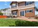 A lovely outdoor patio extends to a lush green backyard with chairs and a grill at 3912 Miners Candle Pl, Castle Rock, CO 80109