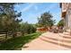 A beautiful outdoor patio extends to a lush green backyard with a charming wooden fence at 3912 Miners Candle Pl, Castle Rock, CO 80109