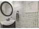Chic powder room features a decorative mirror and trendy wallpaper at 3912 Miners Candle Pl, Castle Rock, CO 80109