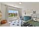 Bedroom with plenty of natural light and views, blue chest and minimalist decor at 3912 Miners Candle Pl, Castle Rock, CO 80109
